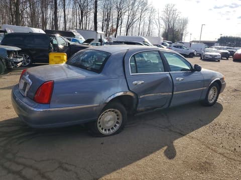 1999 Lincoln Town Car, VIN 1LNHM81WXXY658411. Photo 3 of 6 from Copart auction. OpenDataCar US salvage catalog.